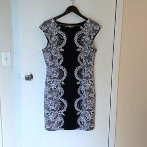 Black dress with white lace detail.